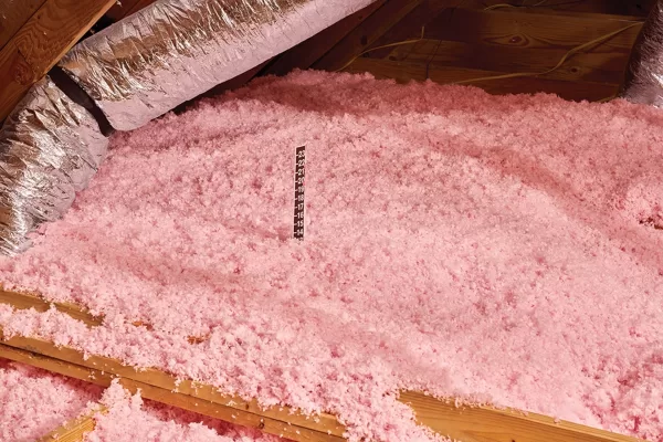 Loose-Fill-Insulation-e1710358128376 (1) Loose fill insulation being measured with a ruler.